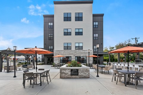 A modern building with a courtyard in front.