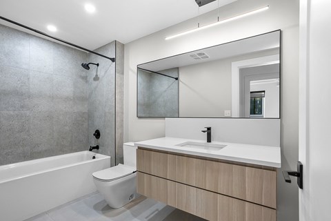 a bathroom with a toilet sink and a shower
