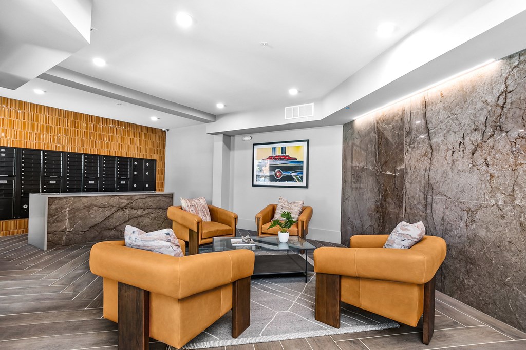 A modern living room with a grey marble wall and a wooden floor.
