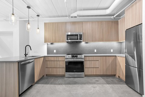 a kitchen with wooden cabinets and stainless steel appliances