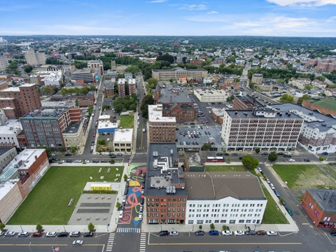 an aerial view of a city with buildings and a green park at 1188 Lofts in Bridgeport