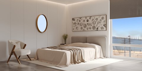 A bedroom with a large bed and a view of the beach.