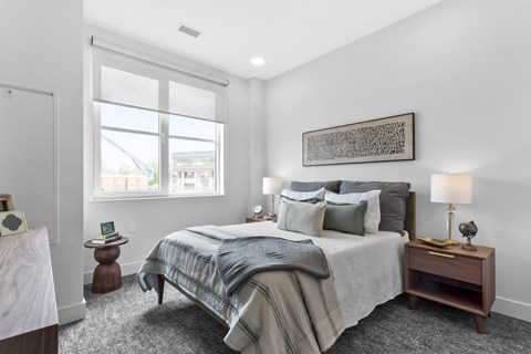 A bedroom with a large bed and a window.