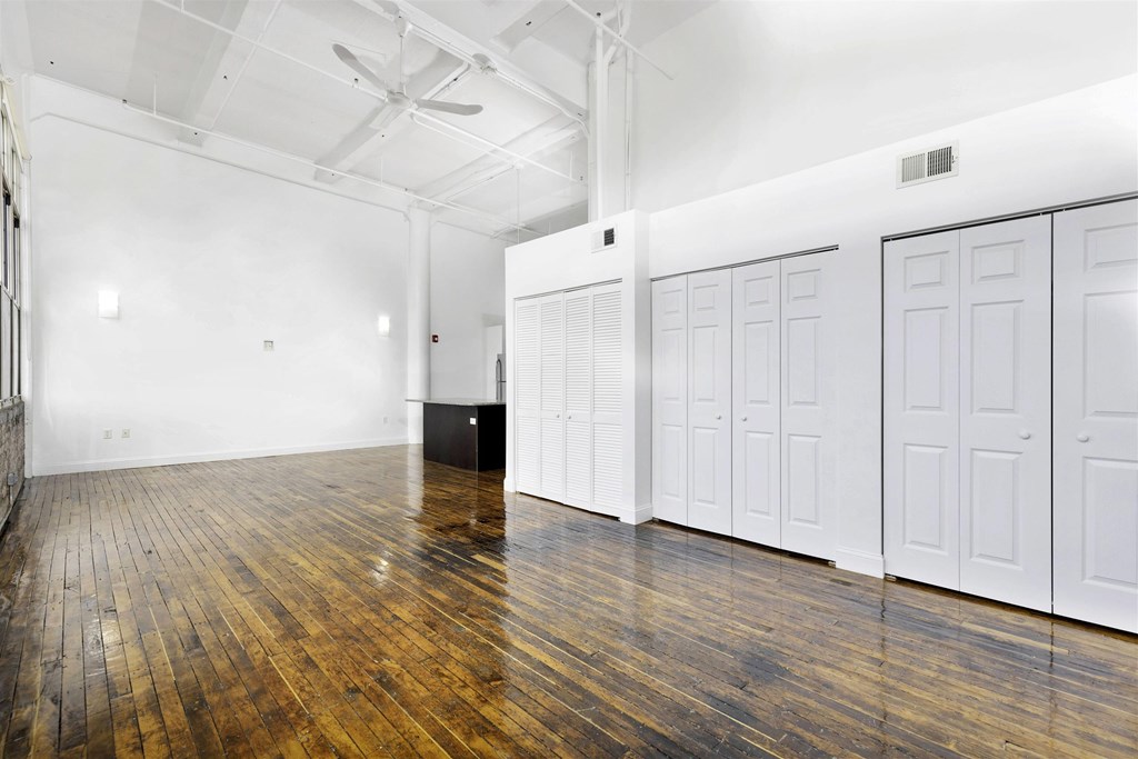 A room with wooden floors and white walls.