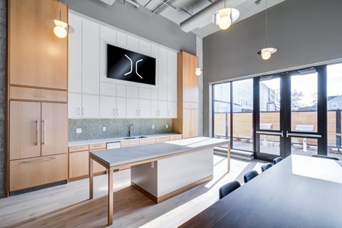 A modern kitchen with a wooden table and cabinets.