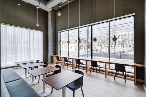 A modern dining room with a view of the street outside.