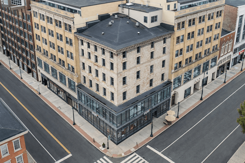 A street view of a city with buildings and a crosswalk.