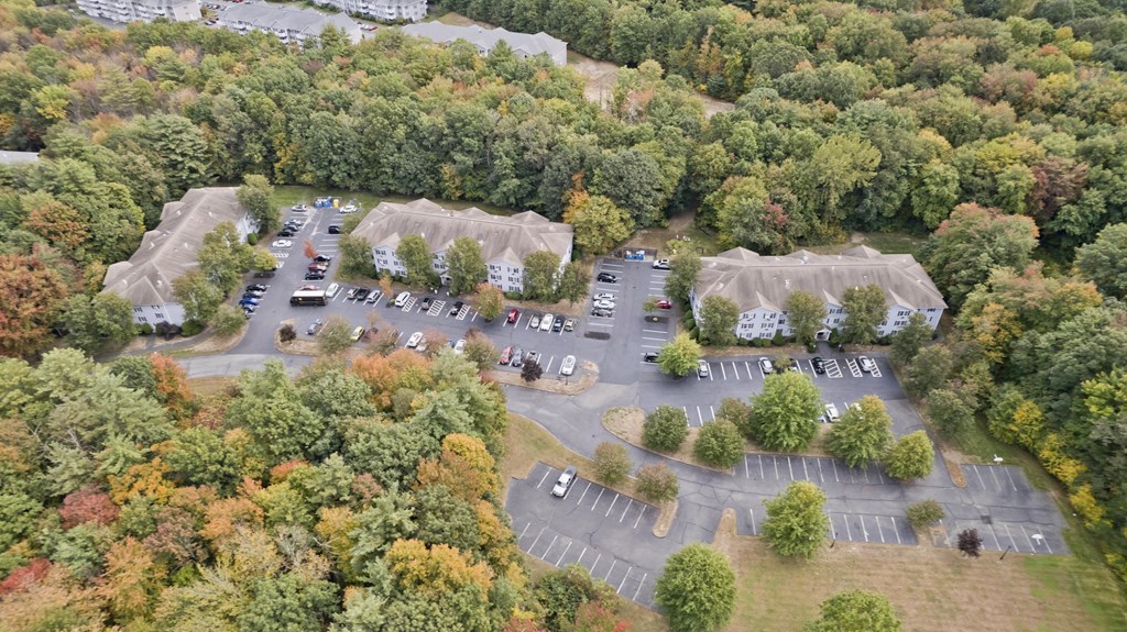 an aerial view of a parking lot with cars and tents