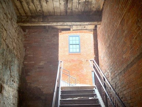 the stairs to the top of a brick building