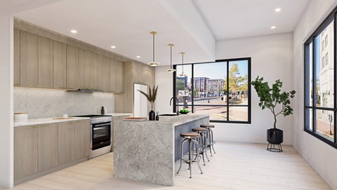 A modern kitchen with a large island and bar stools.