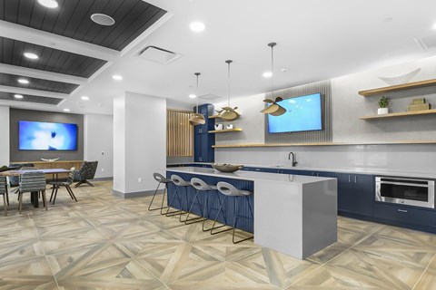 A modern kitchen with a dining table and chairs.