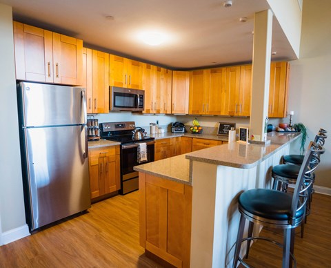 a kitchen with wooden cabinets and stainless steel appliances