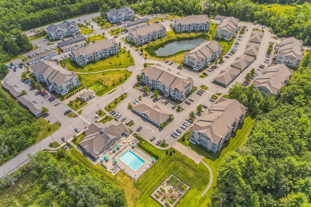 an aerial view of a neighborhood with houses and a pool at The Beacon at Gateway Apartments, Scarborough, ME, 04074