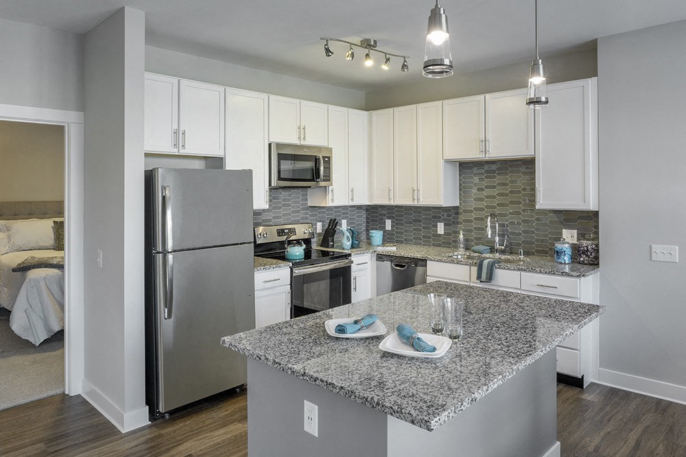a kitchen with granite counter top and stainless steel refrigerator at The Beacon at Gateway Apartments, Scarborough, ME, 04074