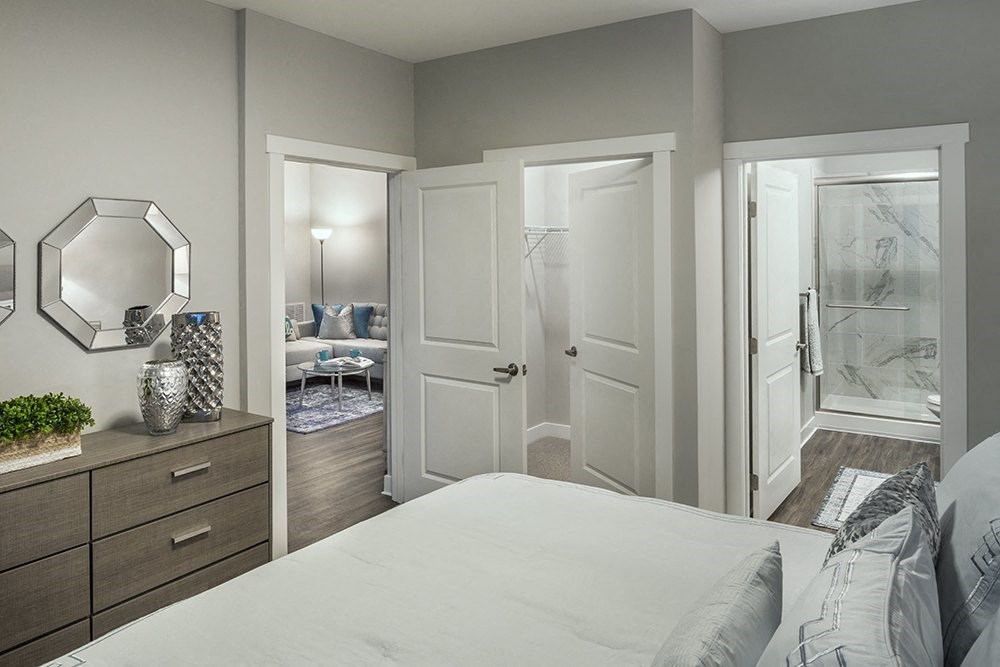 a bedroom with a white bed and a closet at The Beacon at Gateway Apartments, Scarborough, ME, 04074