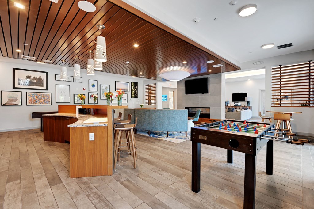 a game room with a pool table and a bar at The Beacon at Gateway Apartments, Scarborough, ME, 04074