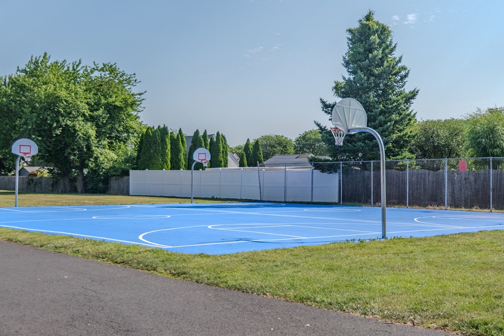 a blue basketball court in a park with two basketball hoops at Glen Hollow, Croydon, Pennsylvania