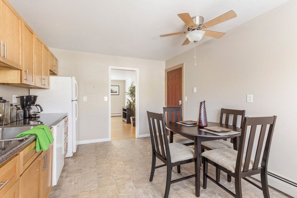 Dining room and kitchen with a table and chairs at Griswold Gardens in Glastonbury, CT, 06033