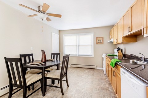 a dining room with a table and chairs in a kitchen