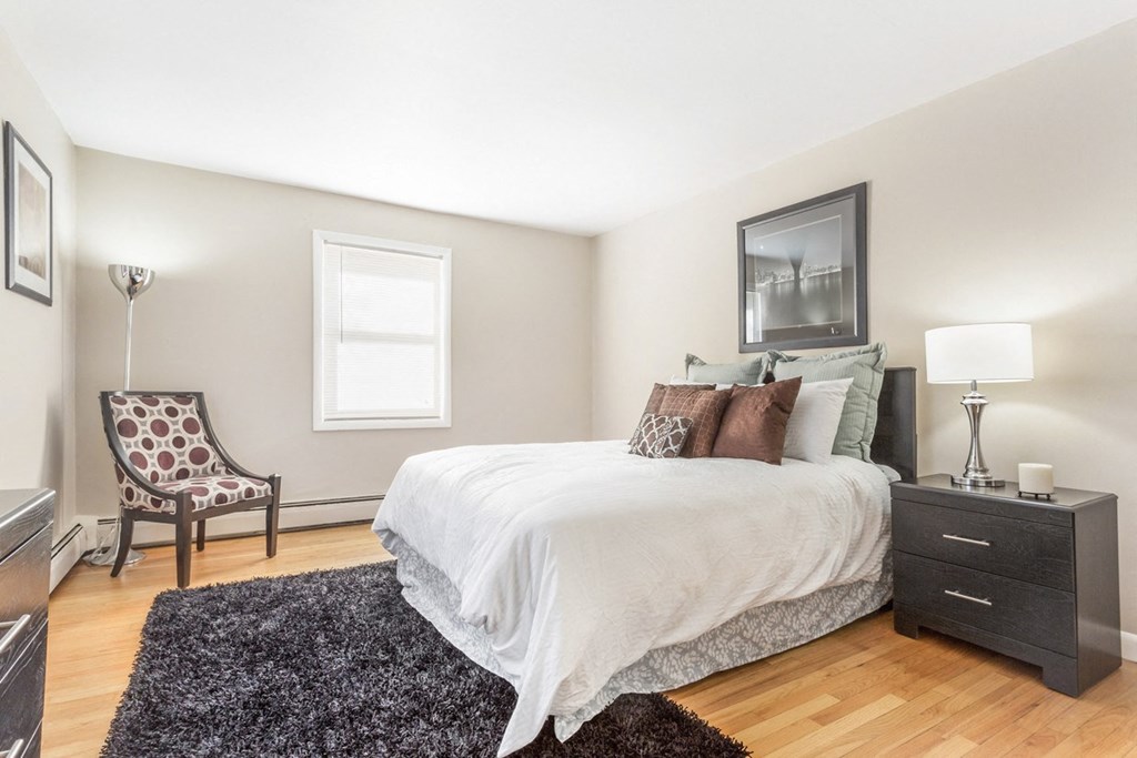 Bedroom with a bed and a chair and a window at Griswold Gardens in Glastonbury, CT, 06033