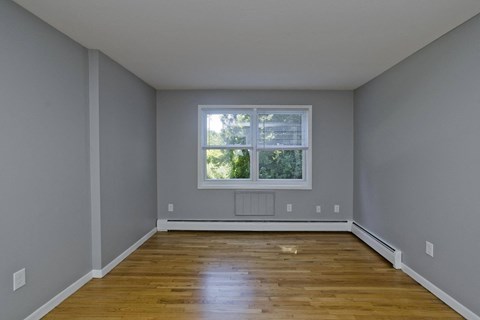 interior view of an empty room with wooden floors and a window at Laurel Ridge in Northampton, MA, 01060