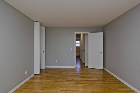 a empty room with wooden floors and grey walls at Laurel Ridge in Northampton, MA, 01060