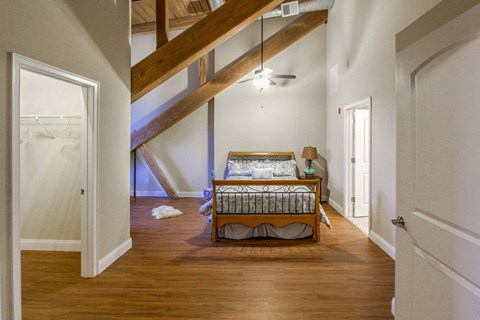 an attic bedroom with a bed and a closet at Ponemah Mills in Taftville, CT, 06380