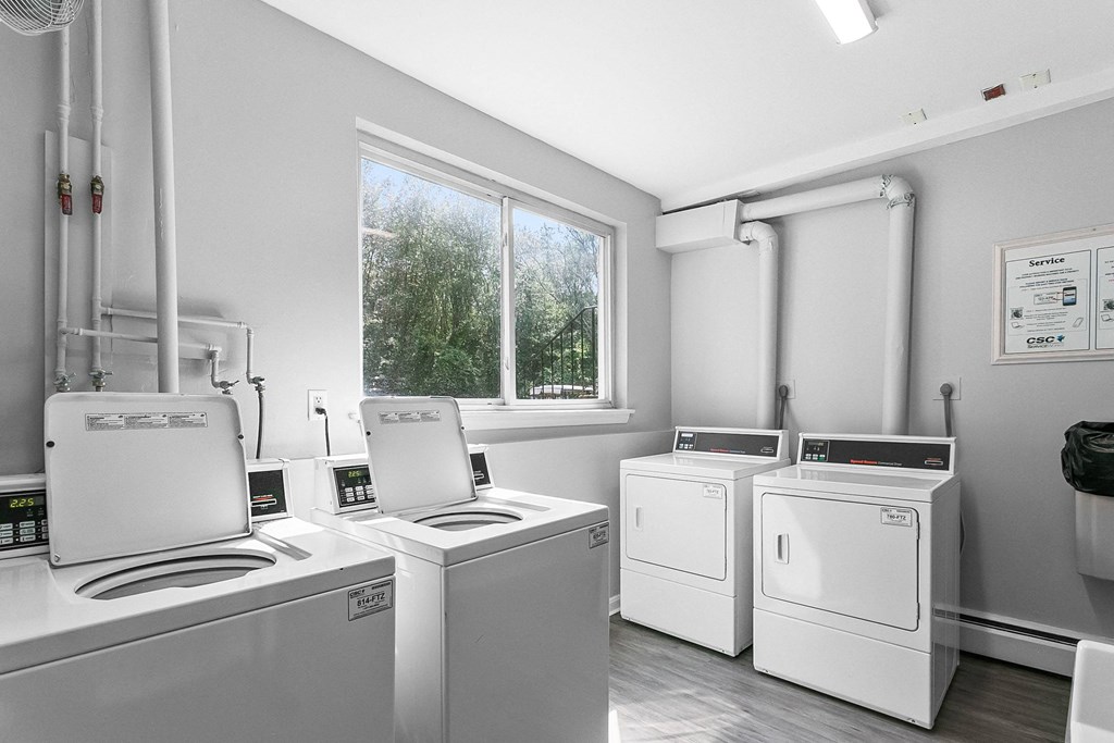 a laundry room with washes and dryers and a window at Rose Hill Estates, Norwich, CT, 06360