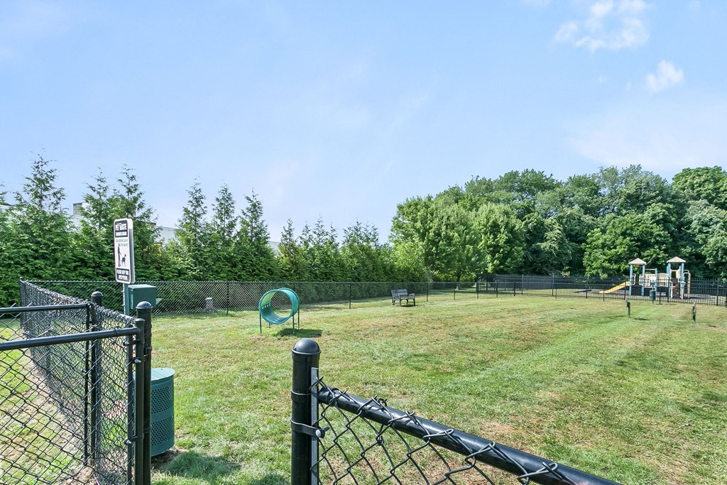 a park with a playground and a chain link fence at Rose Hill Estates, Norwich, CT, 06360
