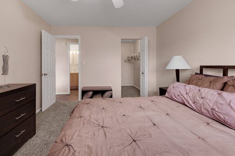 a bedroom with a bed and a dresser and a closet at St Charles Square Apartments, Carol Stream, IL, 60188