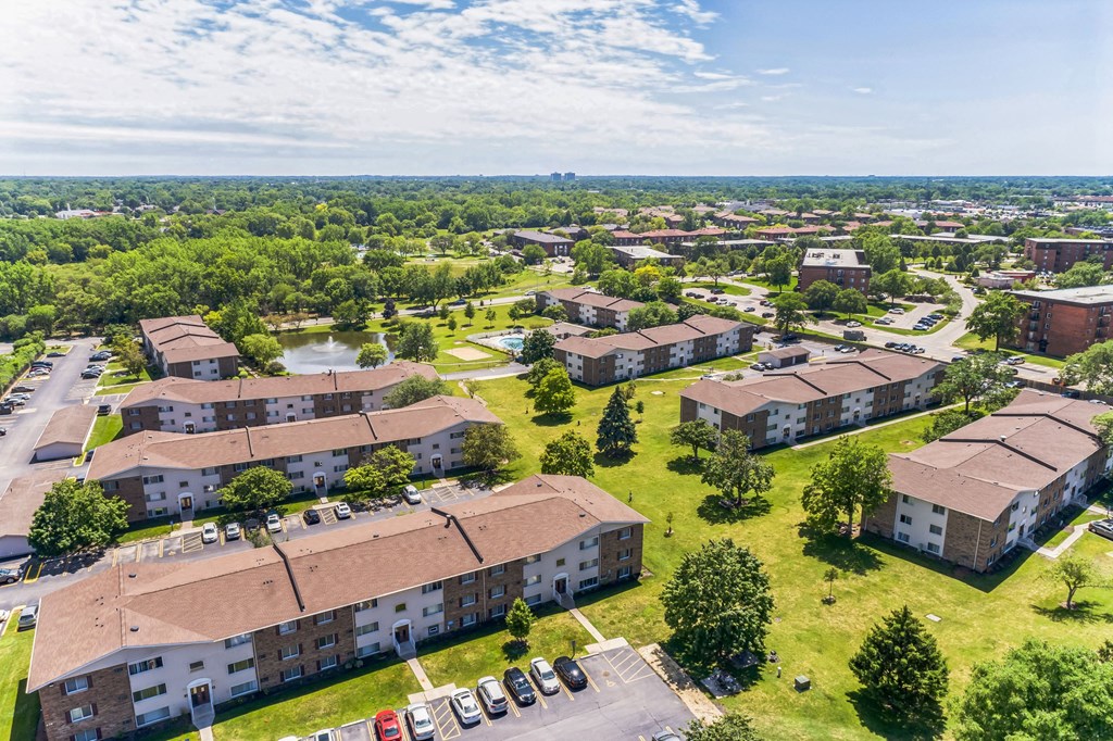 an aerial view of a group of buildings in a city at St Charles Square Apartments, Carol Stream, IL