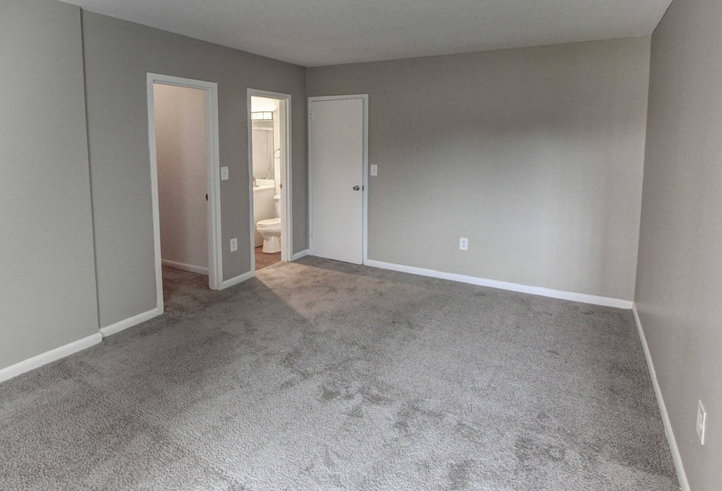 a empty living room with carpet and a door to a bathroom at Stepny Place, Rocky Hill, CT, 06067