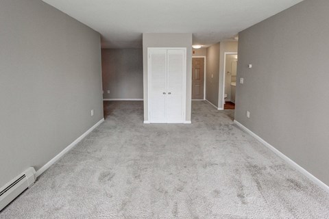 an empty living room with white carpet and a white door at Stepny Place, Rocky Hill, CT