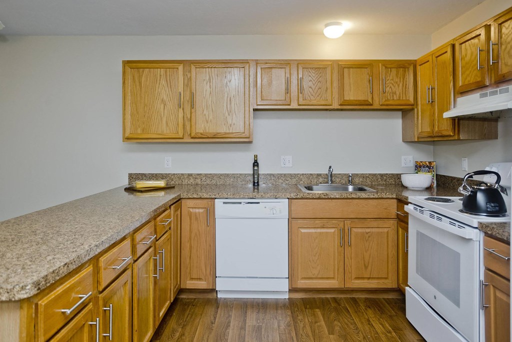 a kitchen with wooden cabinets and a counter top