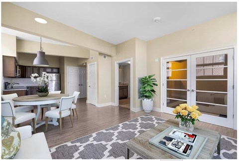 A modern kitchen with a dining table set for four.