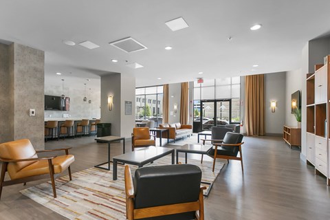 a lounge area with chairs and tables in a lobby at 1188 Lofts, Bridgeport, 06604