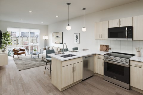 A modern kitchen with a large island and stainless steel appliances.