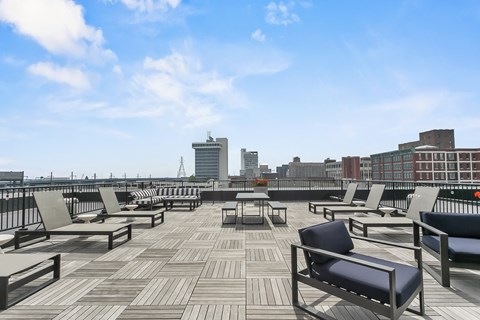 a roof deck with lounge chairs and a view of the city at 1188 Lofts, Connecticut