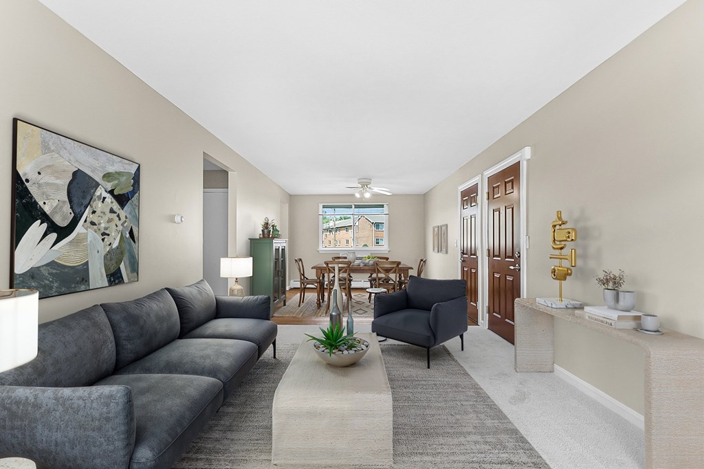 A living room with a grey sofa and a painting on the wall at Rose Hill Estates, Norwich, CT, 06360