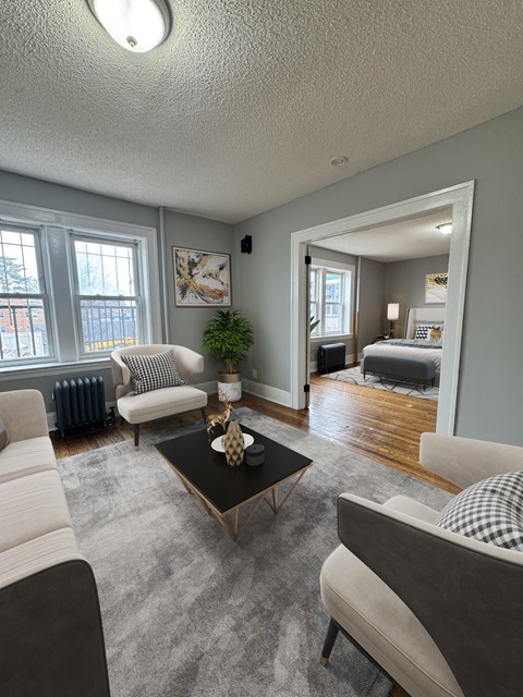 A living room with a black coffee table and a grey sofa.