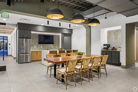 A modern dining room with a wooden table and chairs.