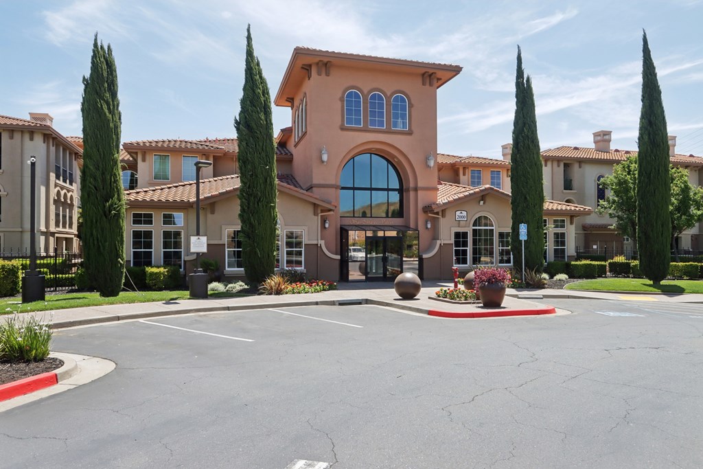 A large building with a red roof and a large arched window.