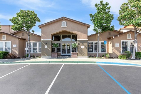 A building with a parking lot in front of it.