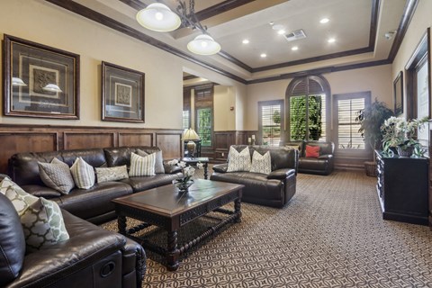 A living room with a brown leather couch and a coffee table.