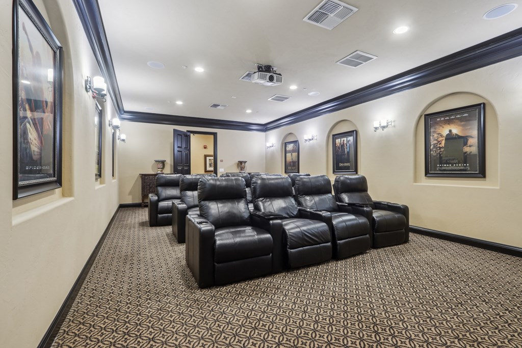 A row of black leather chairs are lined up in a room.