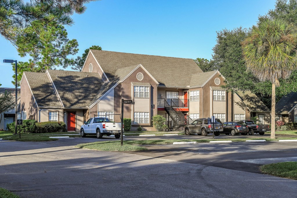 Bloomingdale Woods Apartments Valrico Florida Sunny Day view of Building Exterior surrounded by Trees and Blue Sky