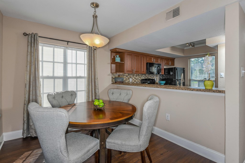 Bloomingdale Woods Apartments Valrico Florida Model Apartment Dining Area with Table and Chairs and view of the kitchen through the half wall