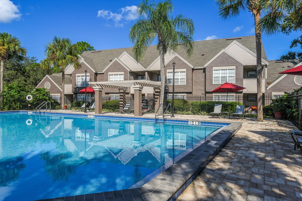 Bloomingdale Woods Apartments Valrico Florida Sunny Pool during day with Umbrellas and Building Exterior
