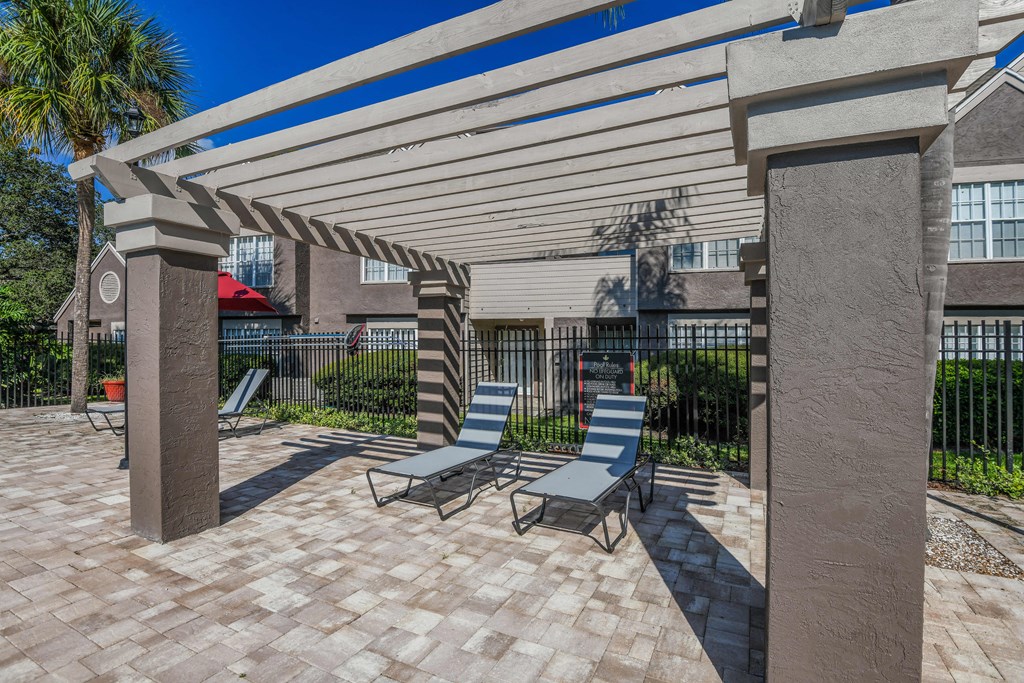 Bloomingdale Woods Apartments Valrico Florida Outdoor Pool During Day Chaise Lounge Chairs under Pergola