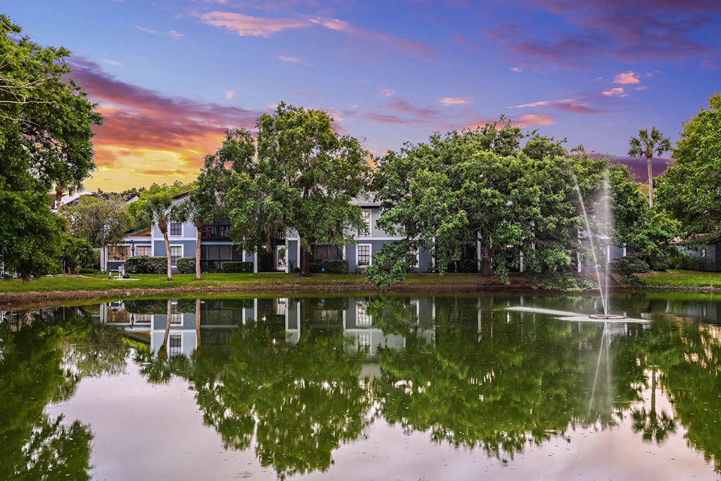 View of Brookside Manor Lake at Sunset with water fountain spraying